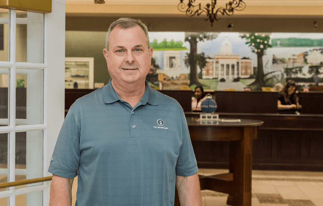 Man standing inside the lobby of First National Bank